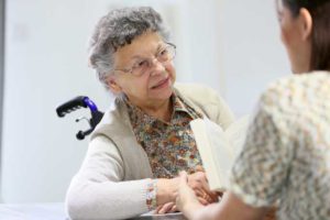 Caregiver holds Elderly Patient's hand